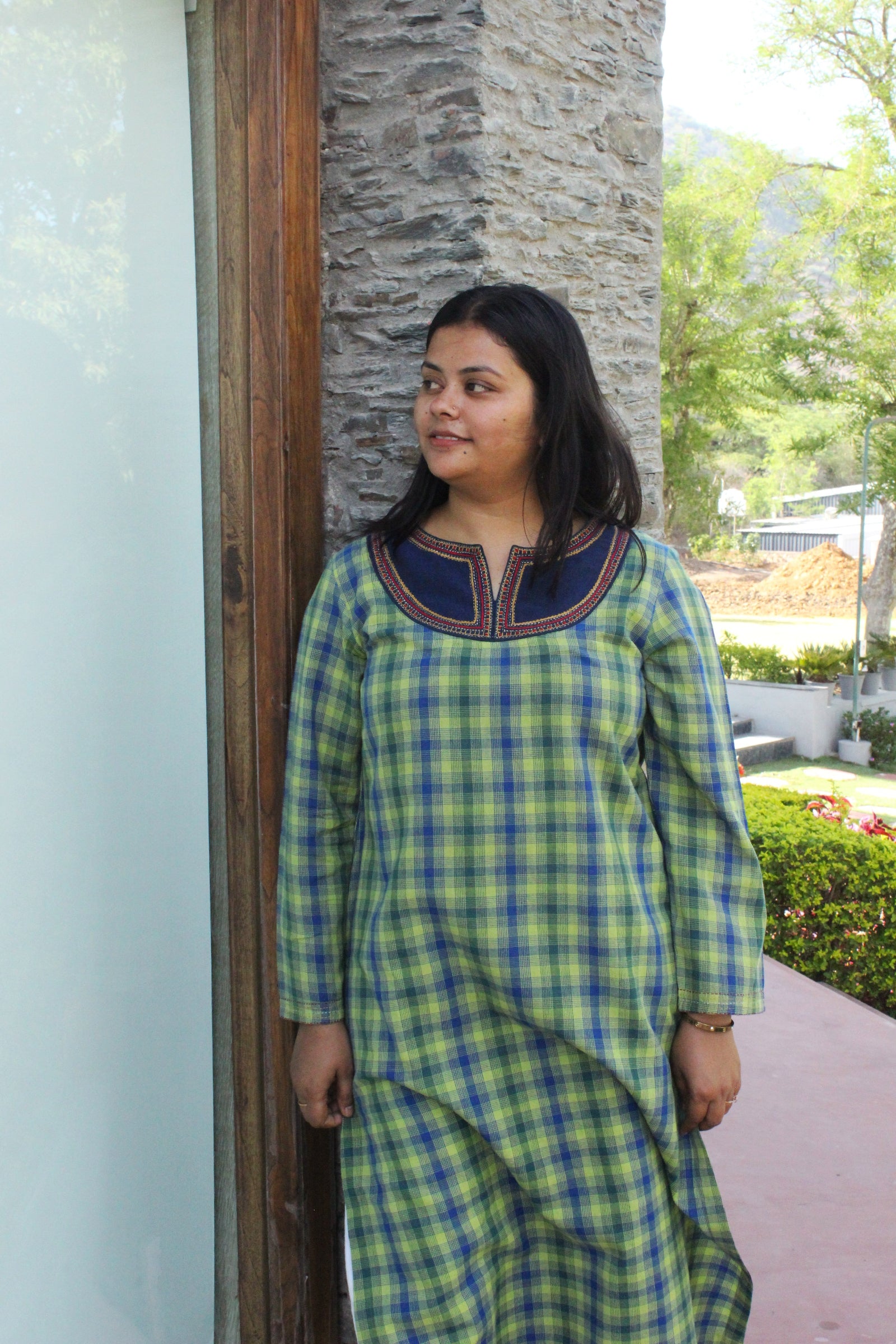 Woman wearing Kashmiri-inspired checkered cotton kurta with navy blue embroidered yoke and long sleeves.