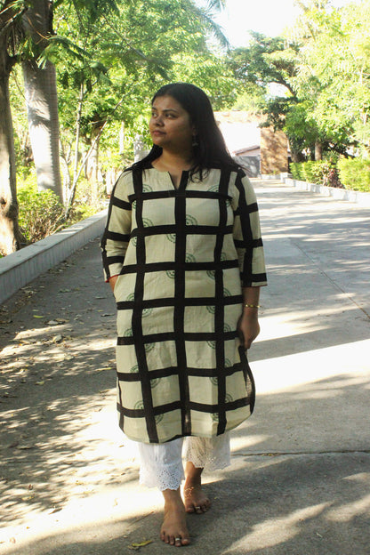 Woman wearing handcrafted off-white straight cotton kurta with checkered print and hand embroidery.