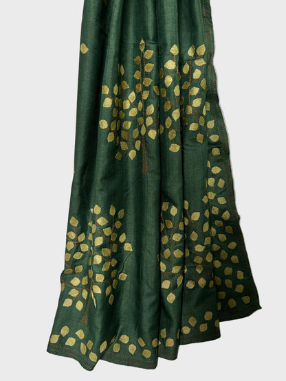 Green fabric with gold leaf patterns on a white background