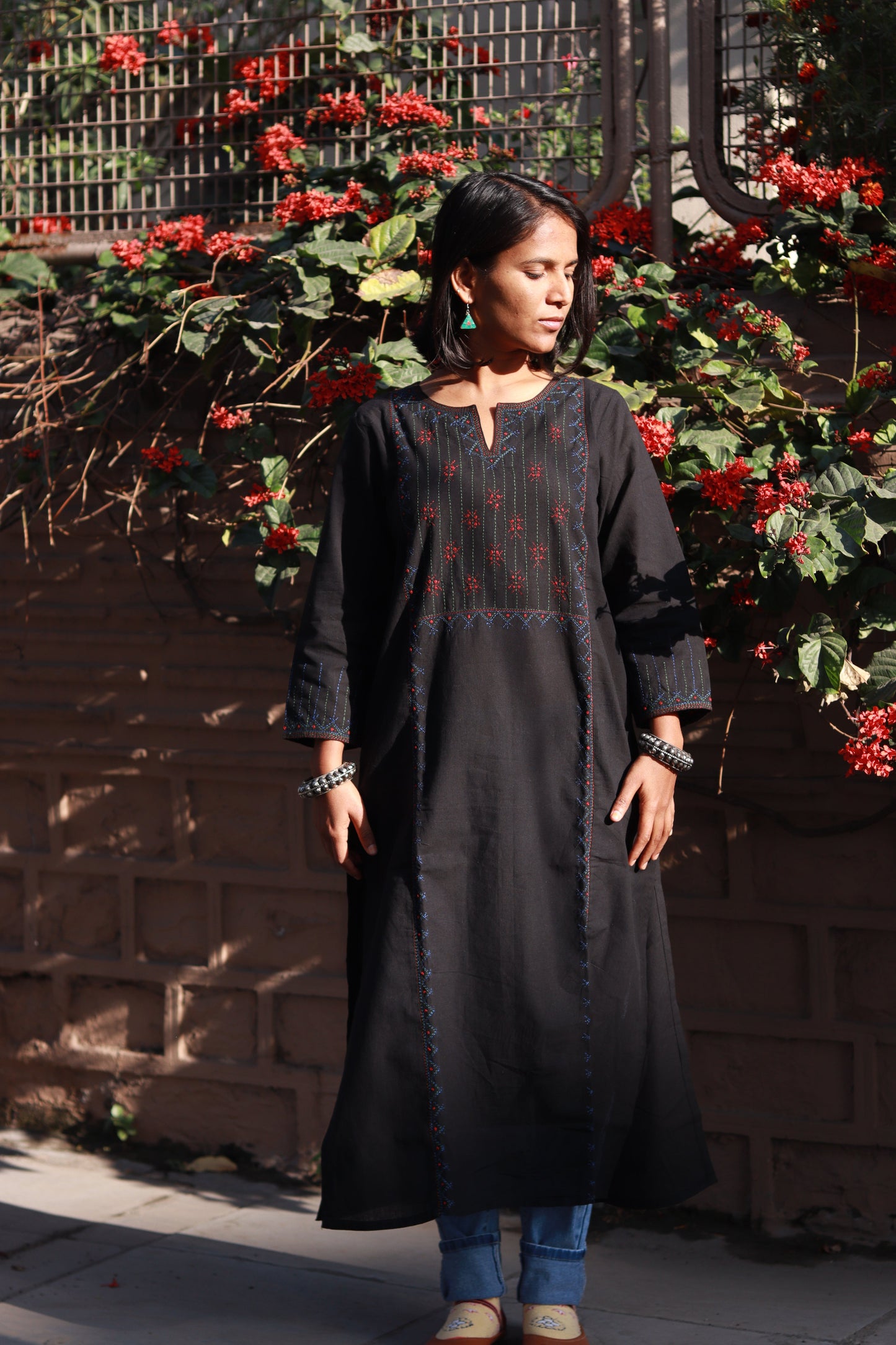 Front view of a woman wearing a Tanka embroidered cotton kurta featuring traditional handmade Indian embroidery, sustainable ethnic wear with side pocket