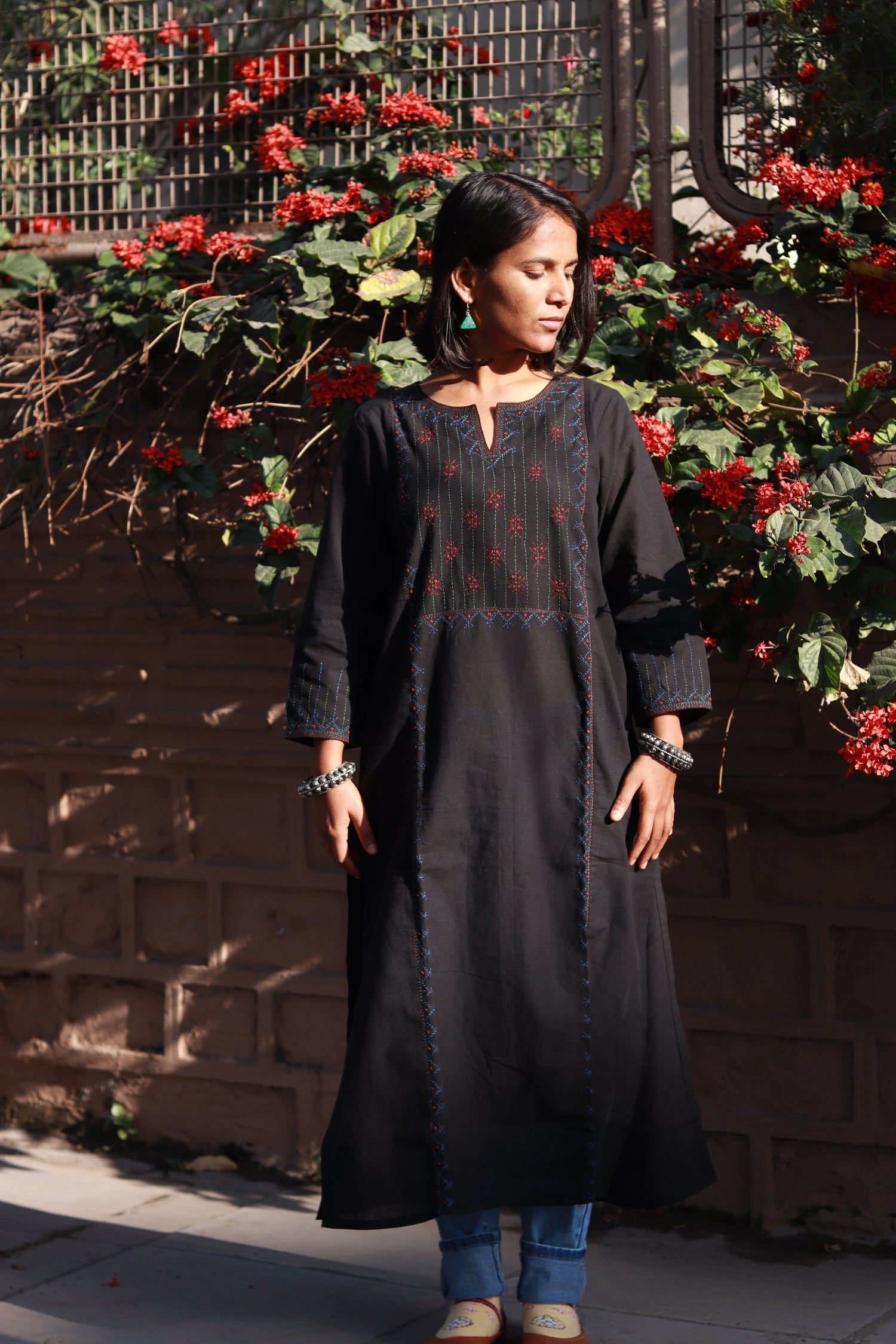 Front view of a woman wearing a Tanka embroidered cotton kurta featuring traditional handmade Indian embroidery, sustainable ethnic wear with side pocket